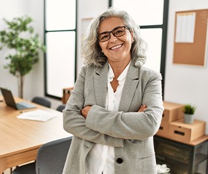 A middle-aged woman smiling while wearing 