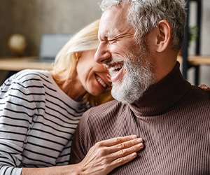 Older couple smiling with dentures