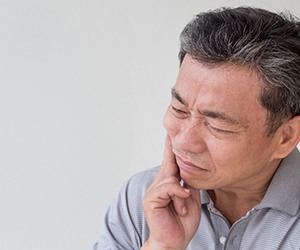 A middle-aged man suffering from a toothache
