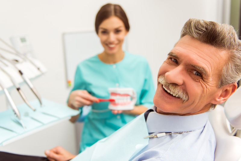 Patient with dentures getting a dental checkup